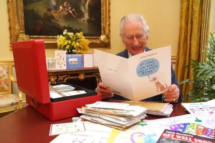 Watch King Charles laughing as he opens cards from public