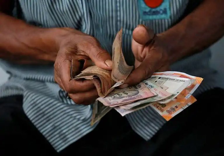 Rupee closes flat, wedged between inflows and local oil companies’ dollar demand