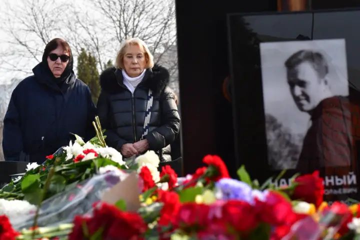 Alexei Navalny’s mother takes flowers to his grave as Russia renews drone strikes on Ukraine