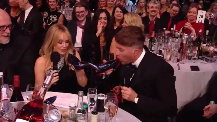 Kylie Minogue shares a ‘shoey’ with Roman Kemp at the Brit Awards