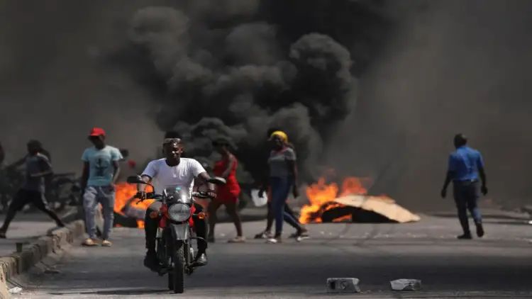 Haiti police struggle as gangs storm biggest prison, their leader seeks to topple PM