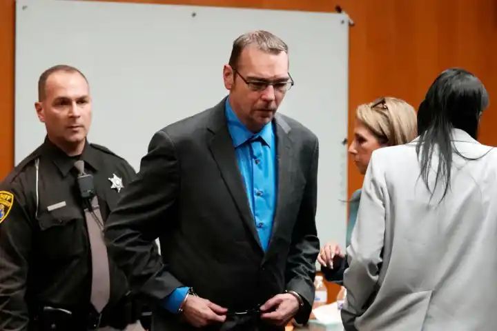 Michigan school shooter’s father accused of making threats in jailhouse phone calls as he goes on trial