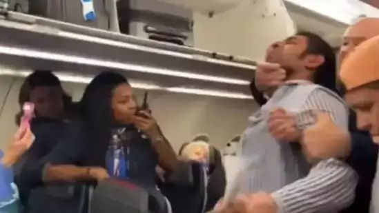 American Airlines passenger headlocked and removed from the plane for lobbing antisemitic slurs at flight attendant